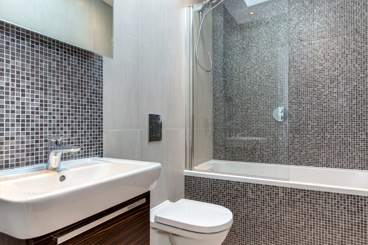 A Bathroom Backsplash With Mosaic Walls