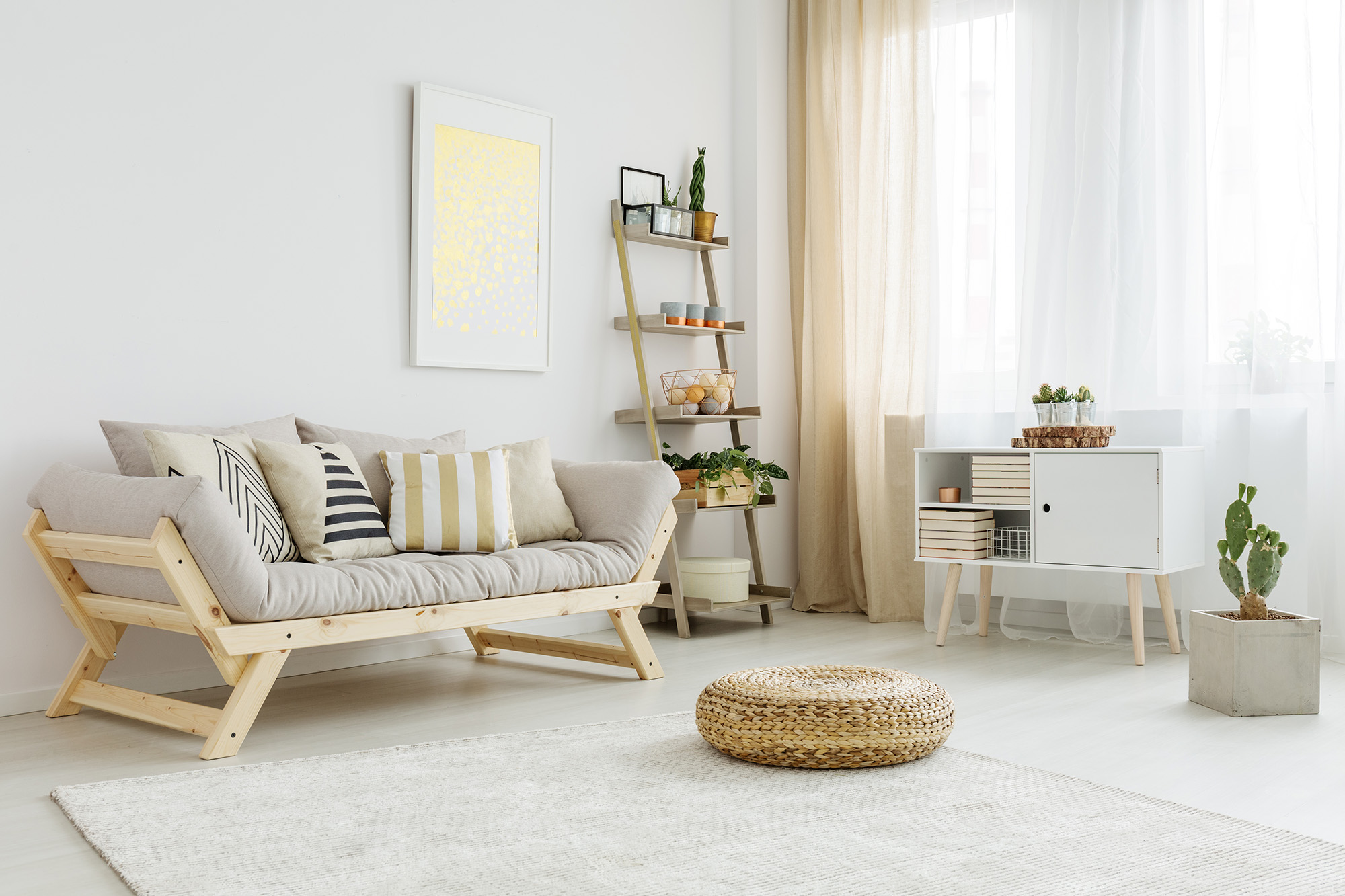 A Living Room With a Light Wood Frame and Grey Cushion