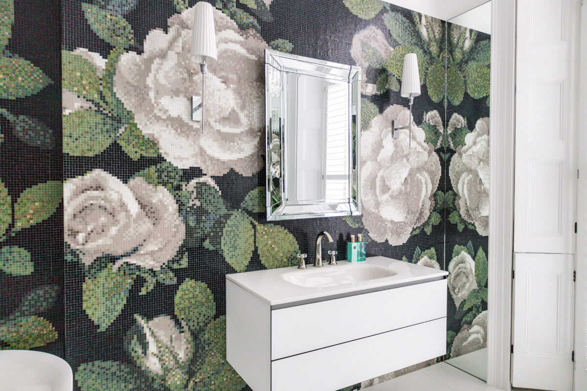 A bathroom with black and white floral wallpaper.