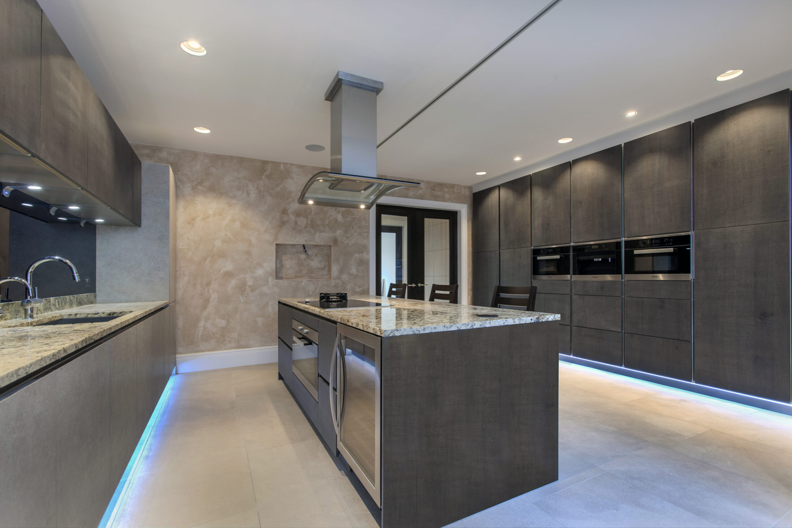A Dark Themed Kitchen With an Island