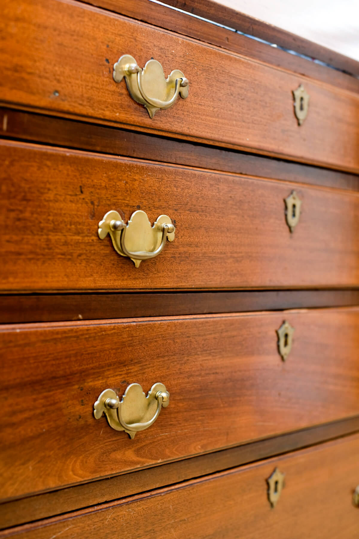 A Wooden Chest of Drawers With Brass Knobs