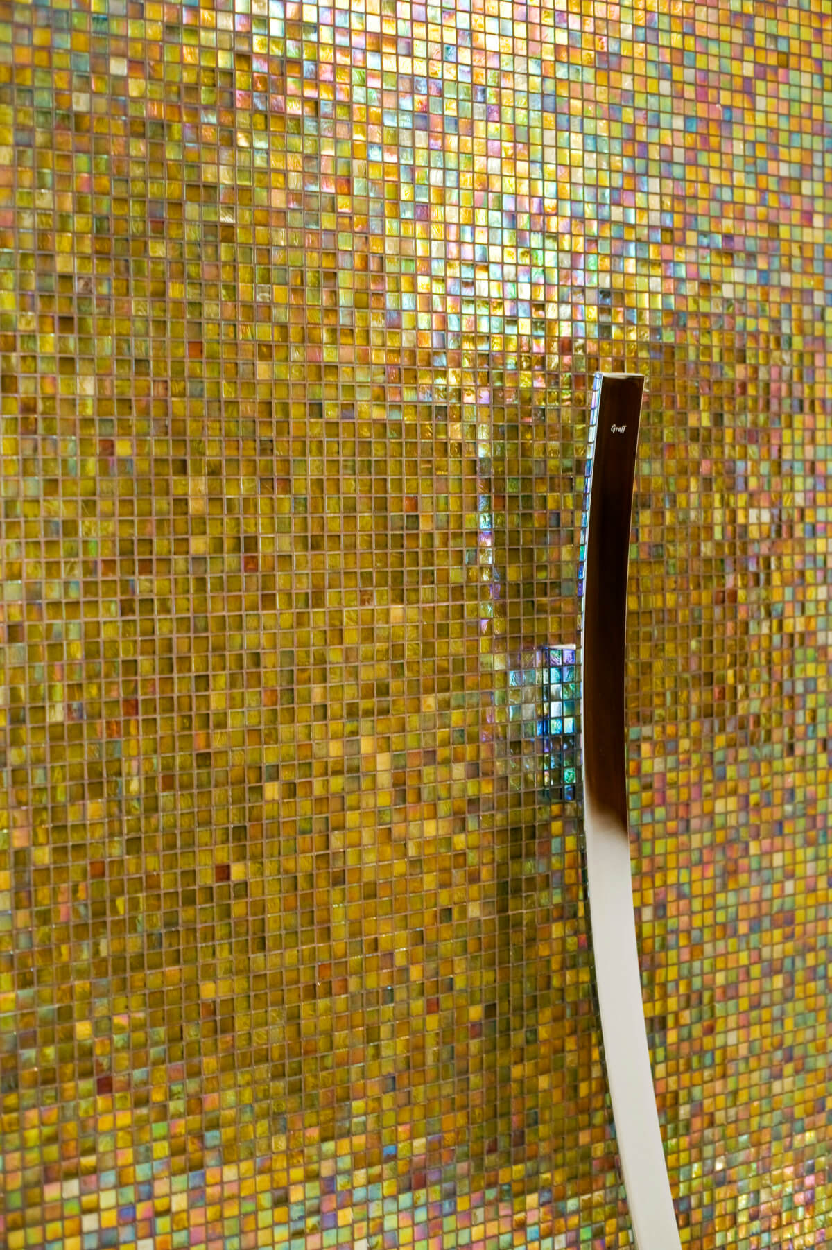 Metallic Bar on a Yellow Tone Mosaic Tile Wall